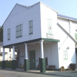 white building with overhanging second floor